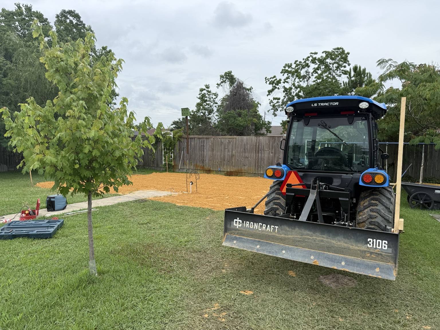 Tractor grading a yard area