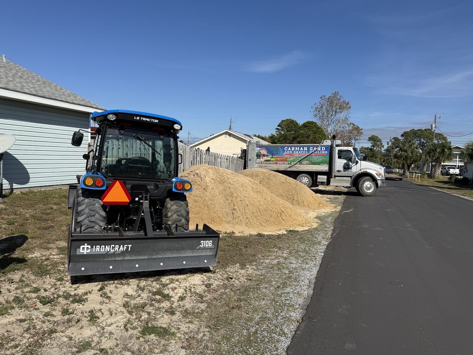 Tractor grading material